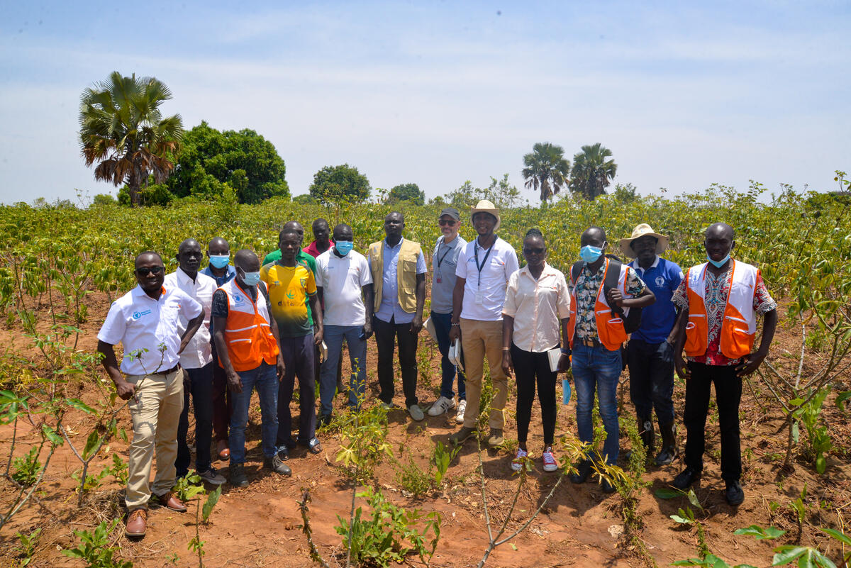 Group of Ugandan farmers and World Vision staff in a field