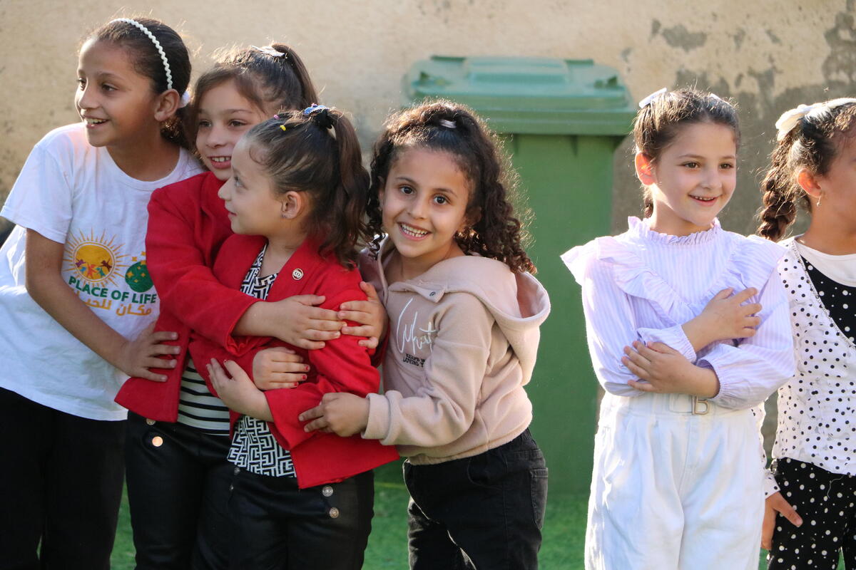 Children huddled together hugging