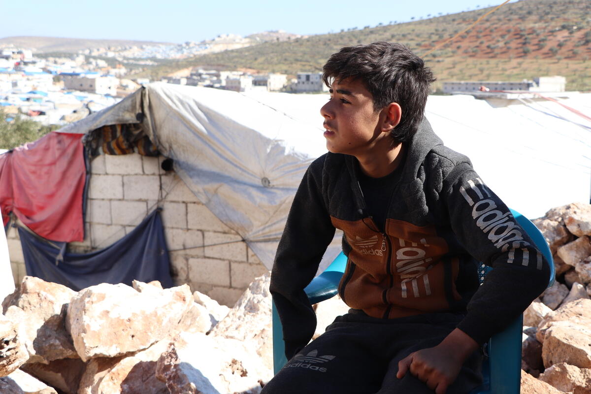 Fadi looks across the camp in north-west Syria