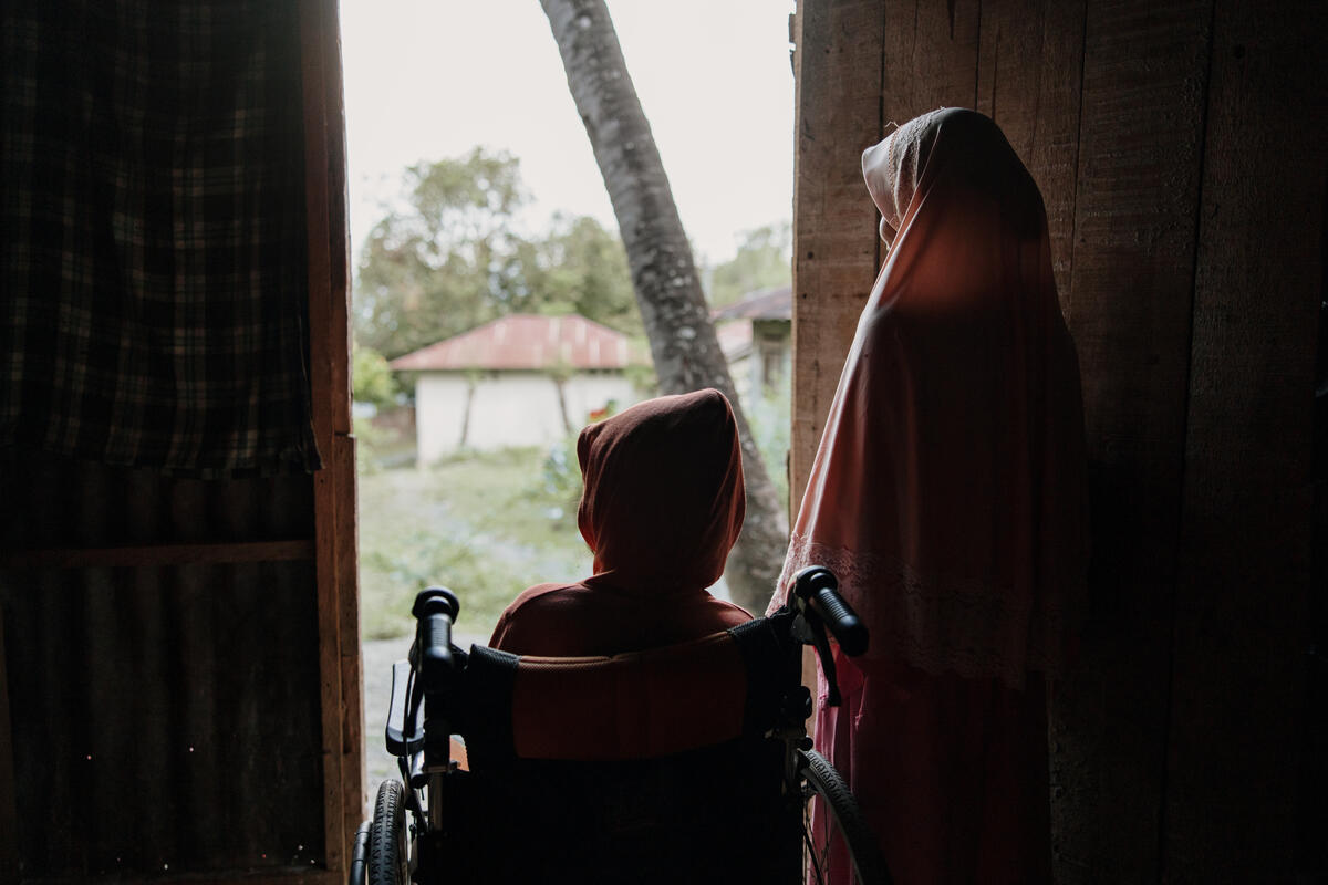 Heda, in a wheelchair, and her mother Desi look out of a doorway