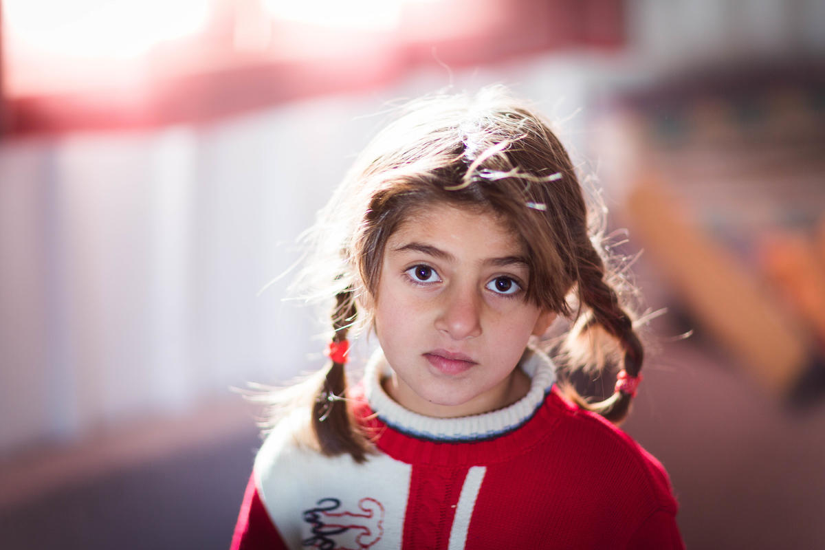 Five-year-old Catherine looks into the sky where she lives with other Syrian refugees. 