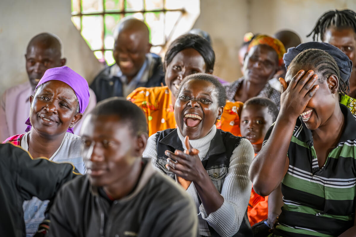 Woman laughing during a World Vision training session in a church in Kenya.