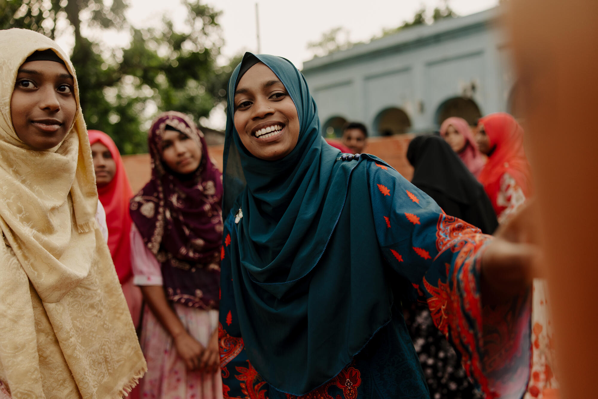Misu talking with friends in her community in Bangladesh.