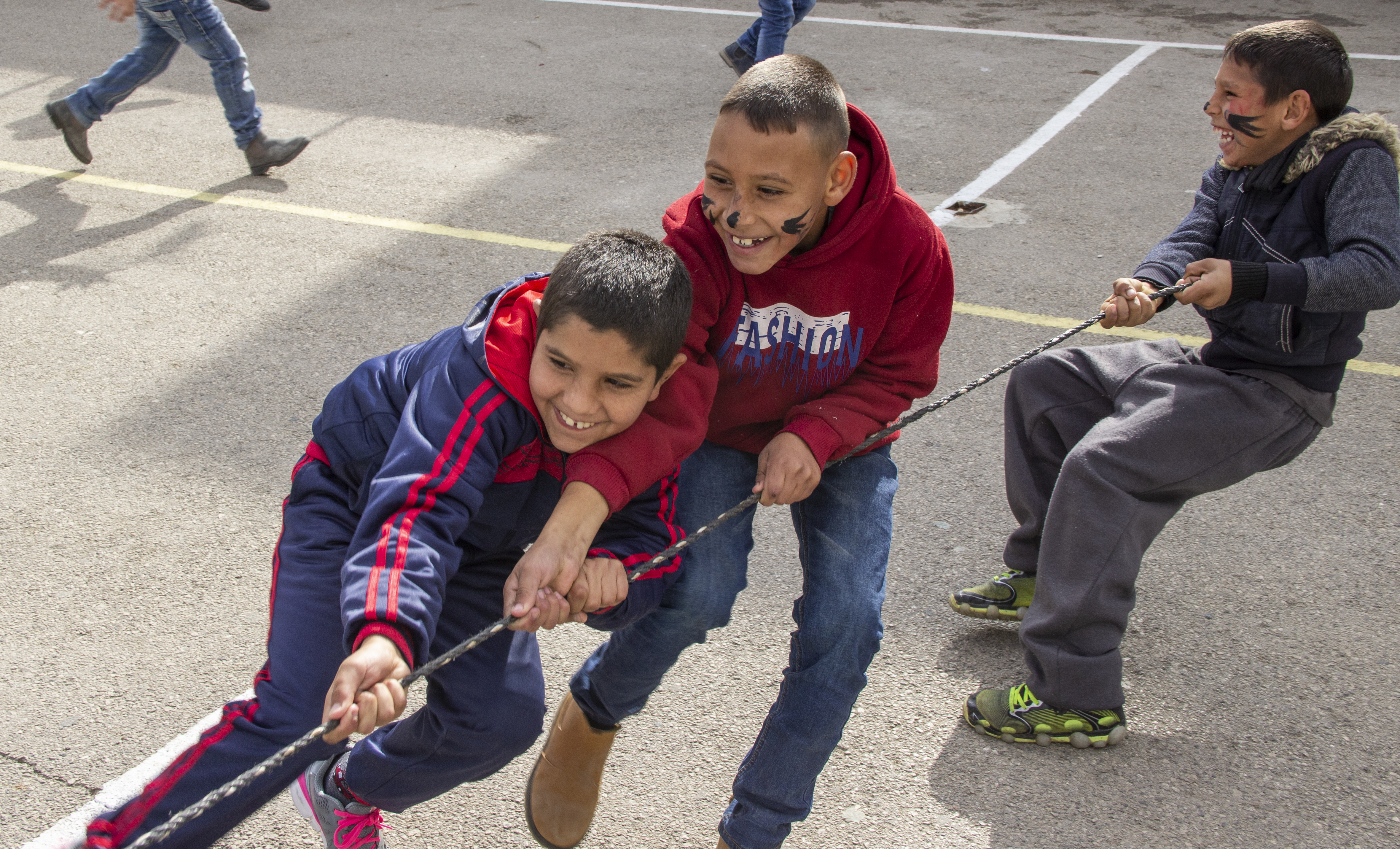 Boys  pull together at tug-of-war