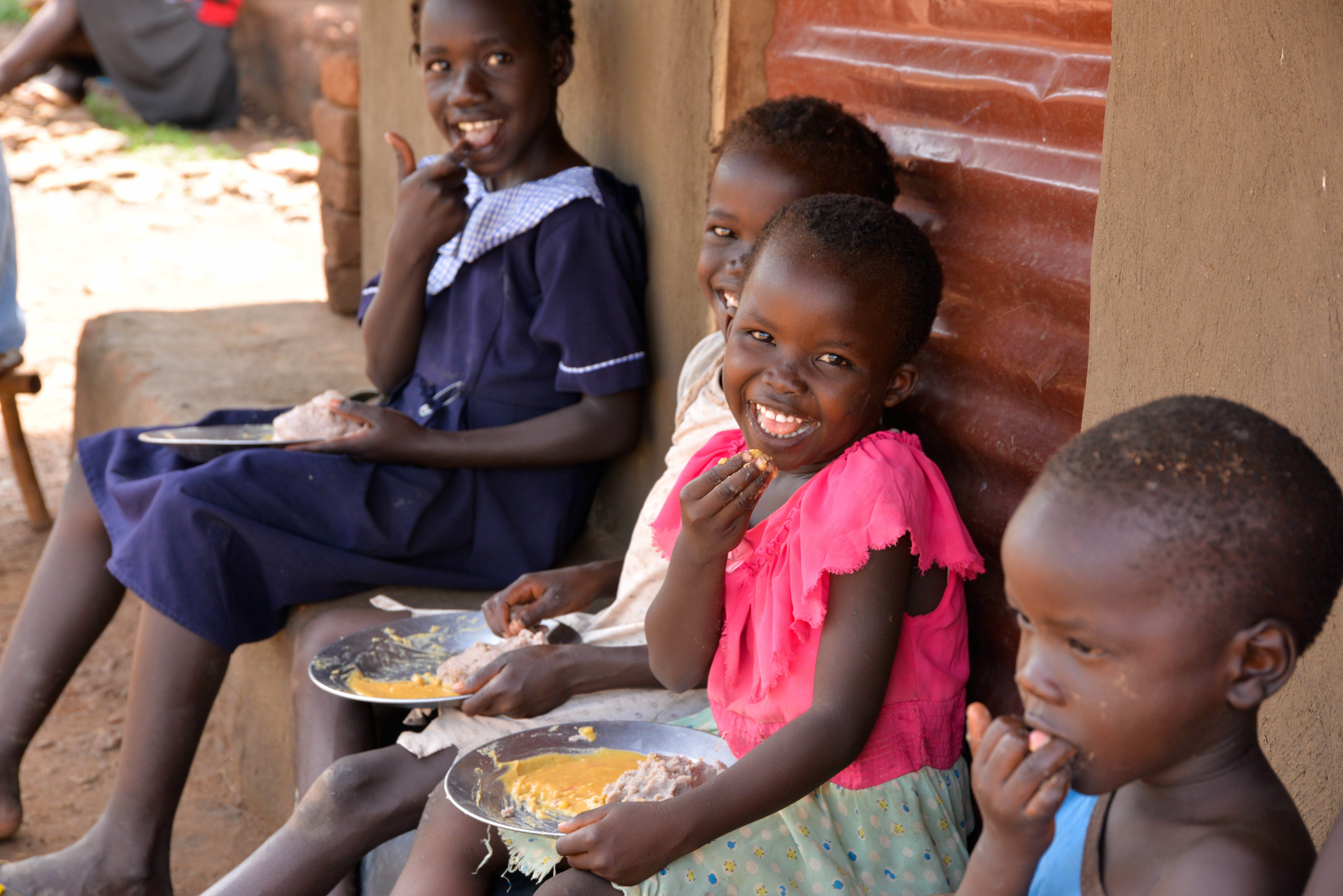 Refugee children from South Sudan enjoying their lunch.