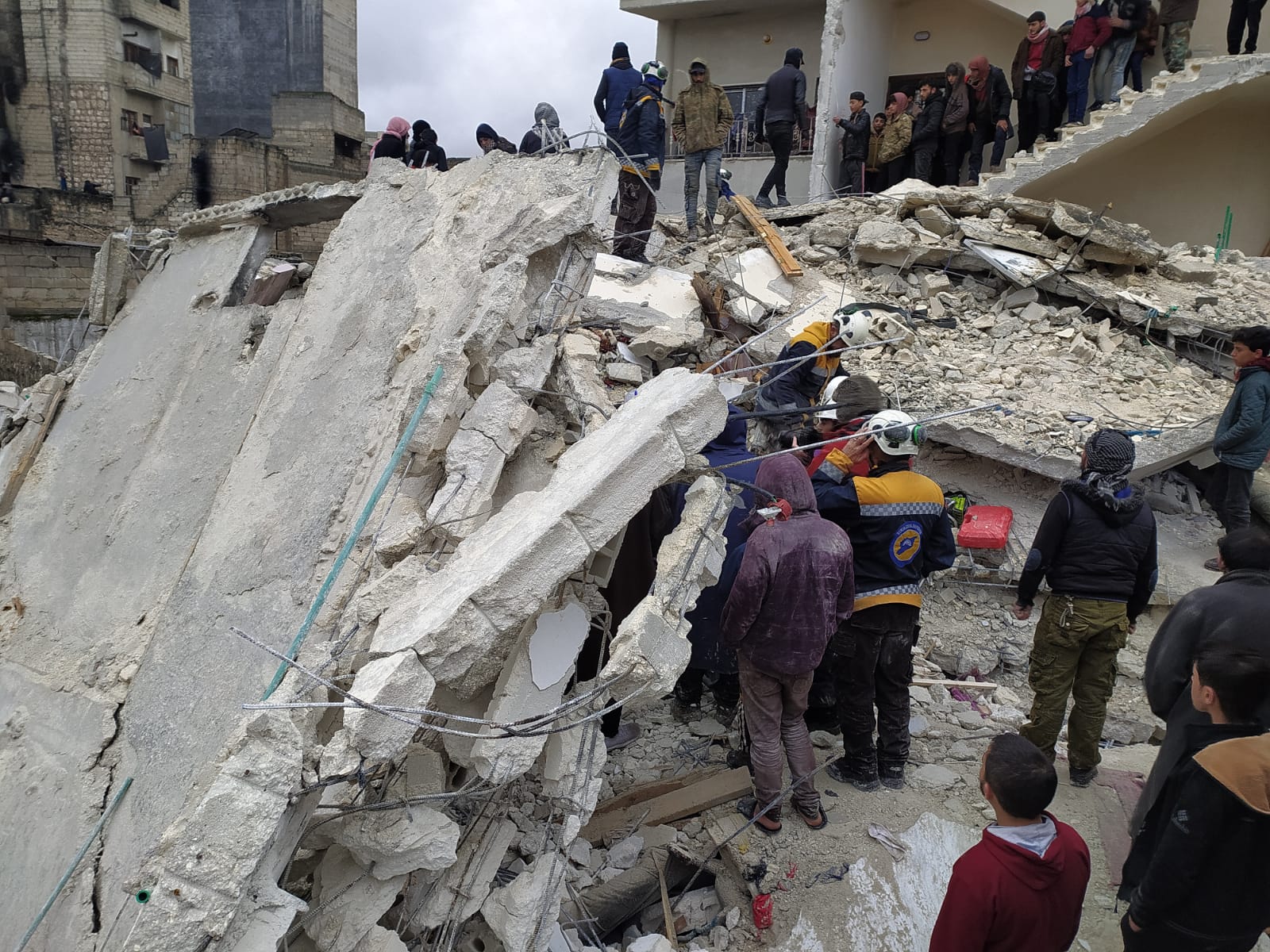First responders and the public searching for people amongst the rubble of buildings flattened by the earthquake in Syria and Turkey