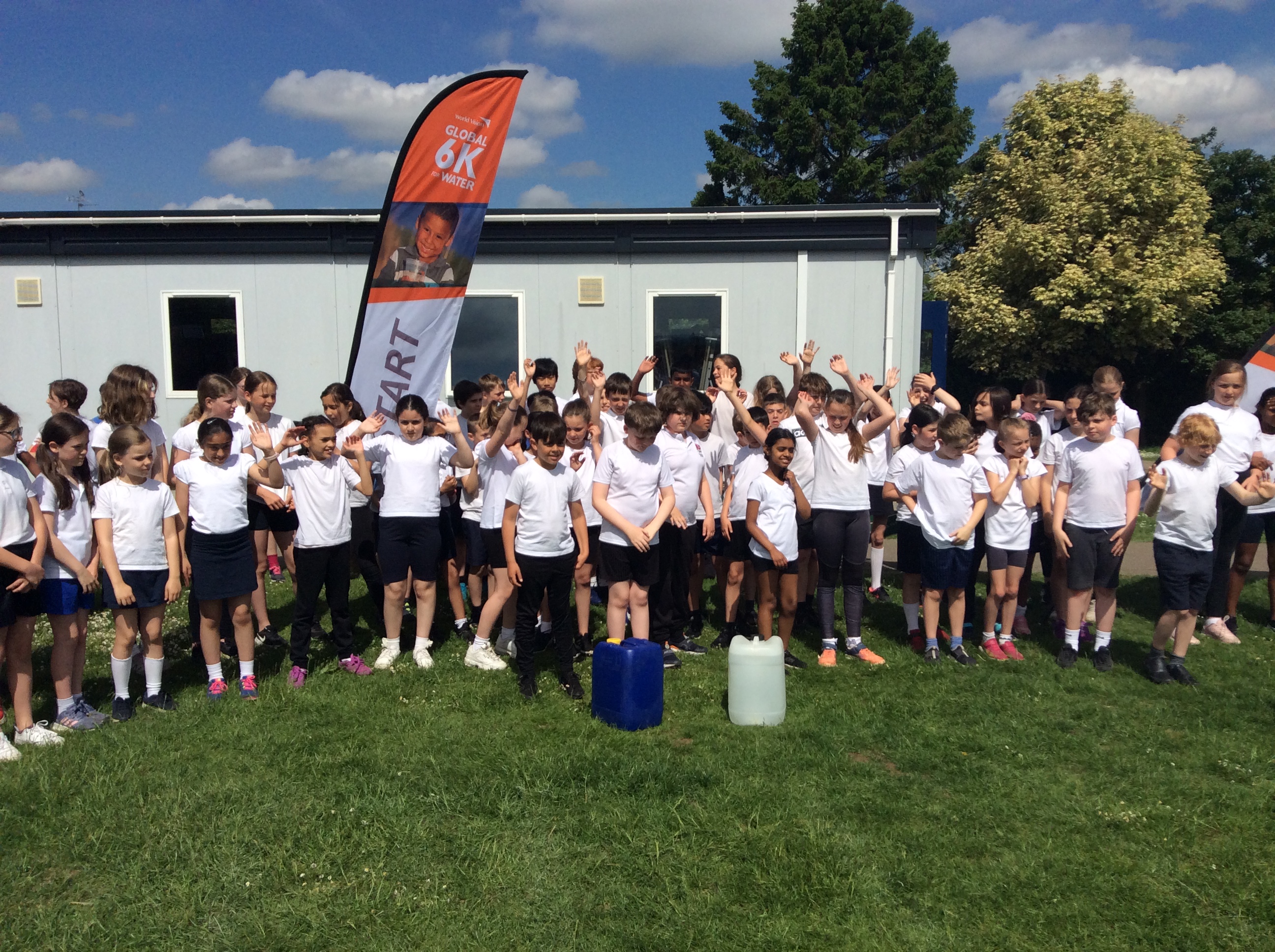 School pupils stand together to celebrate their Global 6K Walk for Water