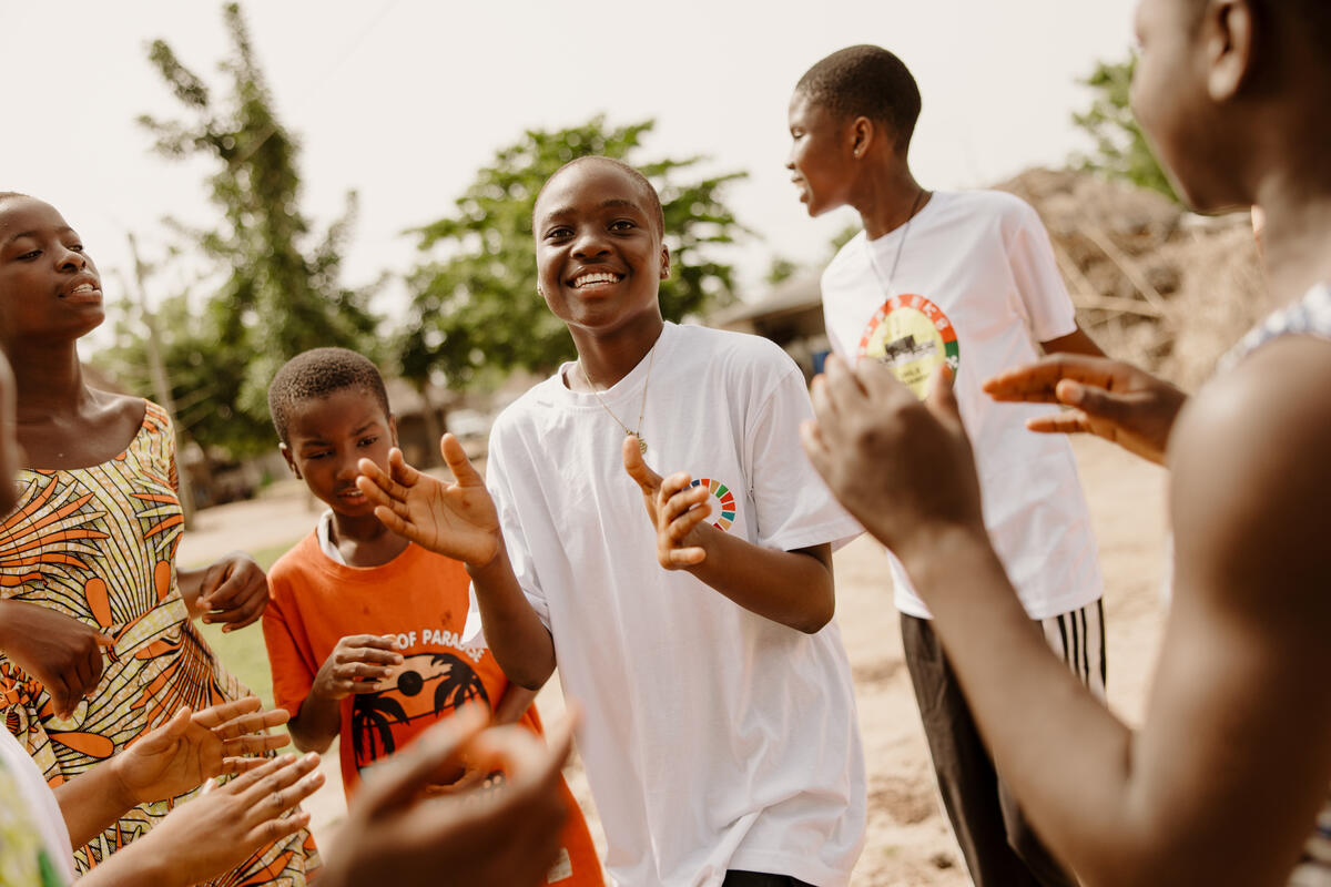 Princess dances with other children in her community.