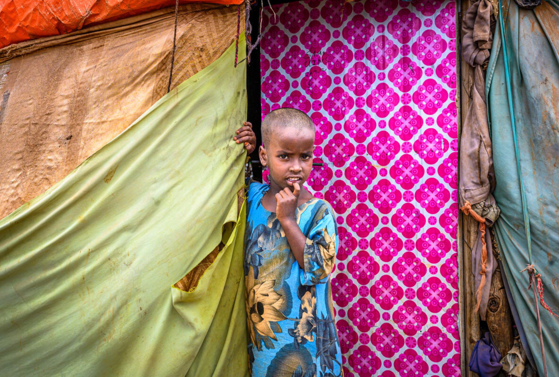 Six-year-old Somali girl standing at the door of the family's IDP shelter