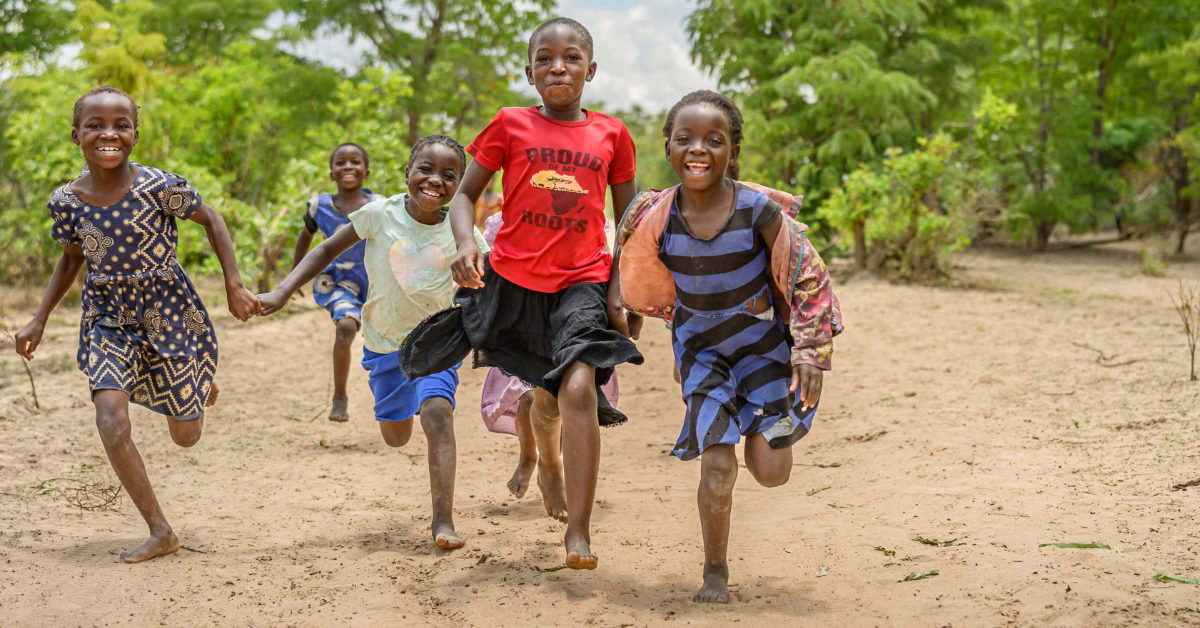 A group of children in Zambia running and having fun