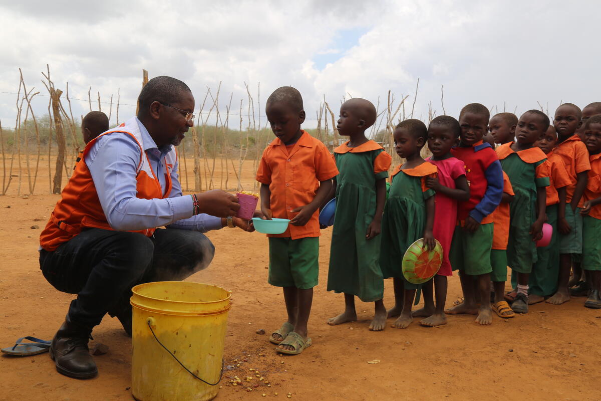 Young children queuing for their lunch at school in Kenya