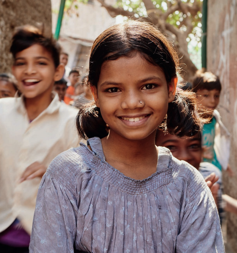 Sponsored child, 11-year-old Kumkum smiles and looks directly to the camera.