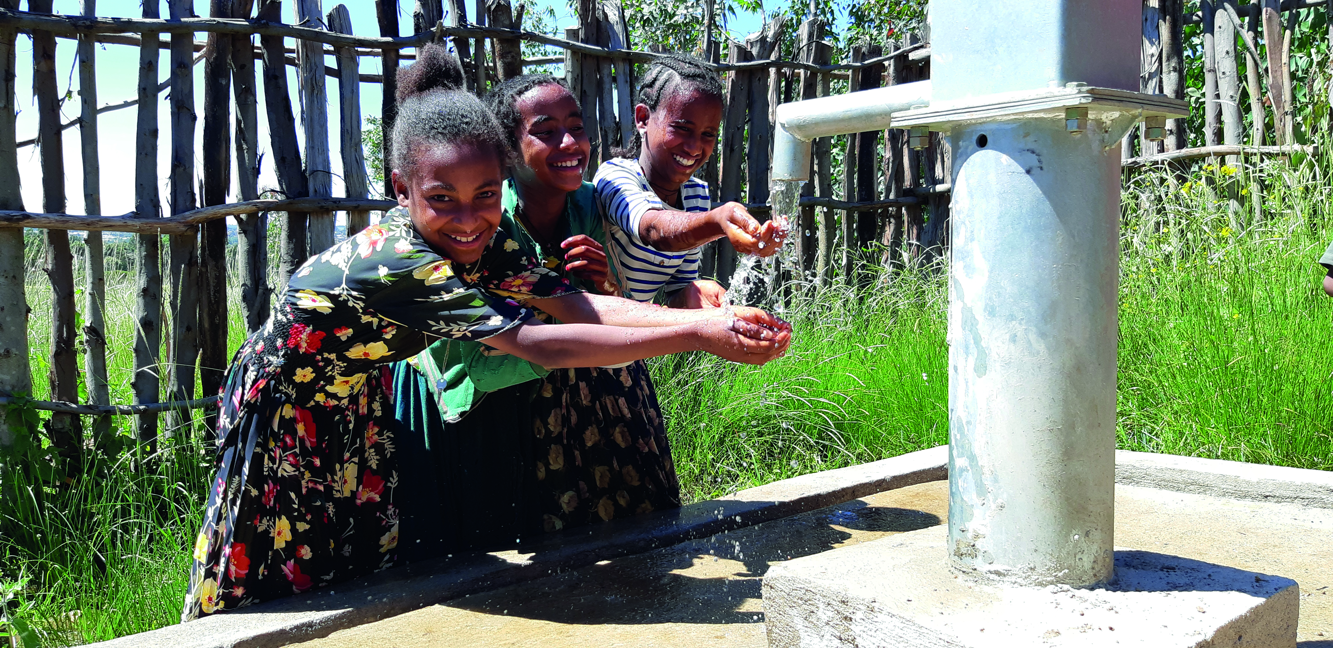Three children washing hands in Yilmana Dense, Ethiopia