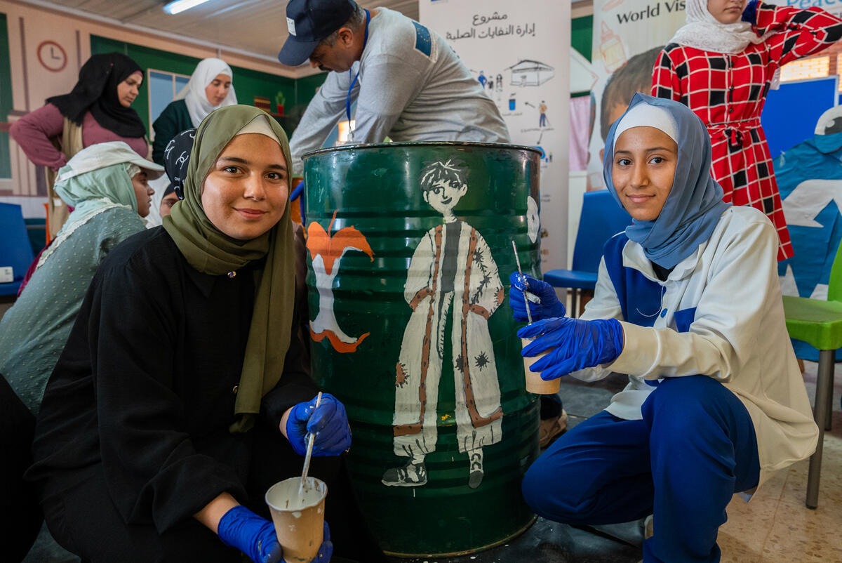 Two girls pose with a barrel
