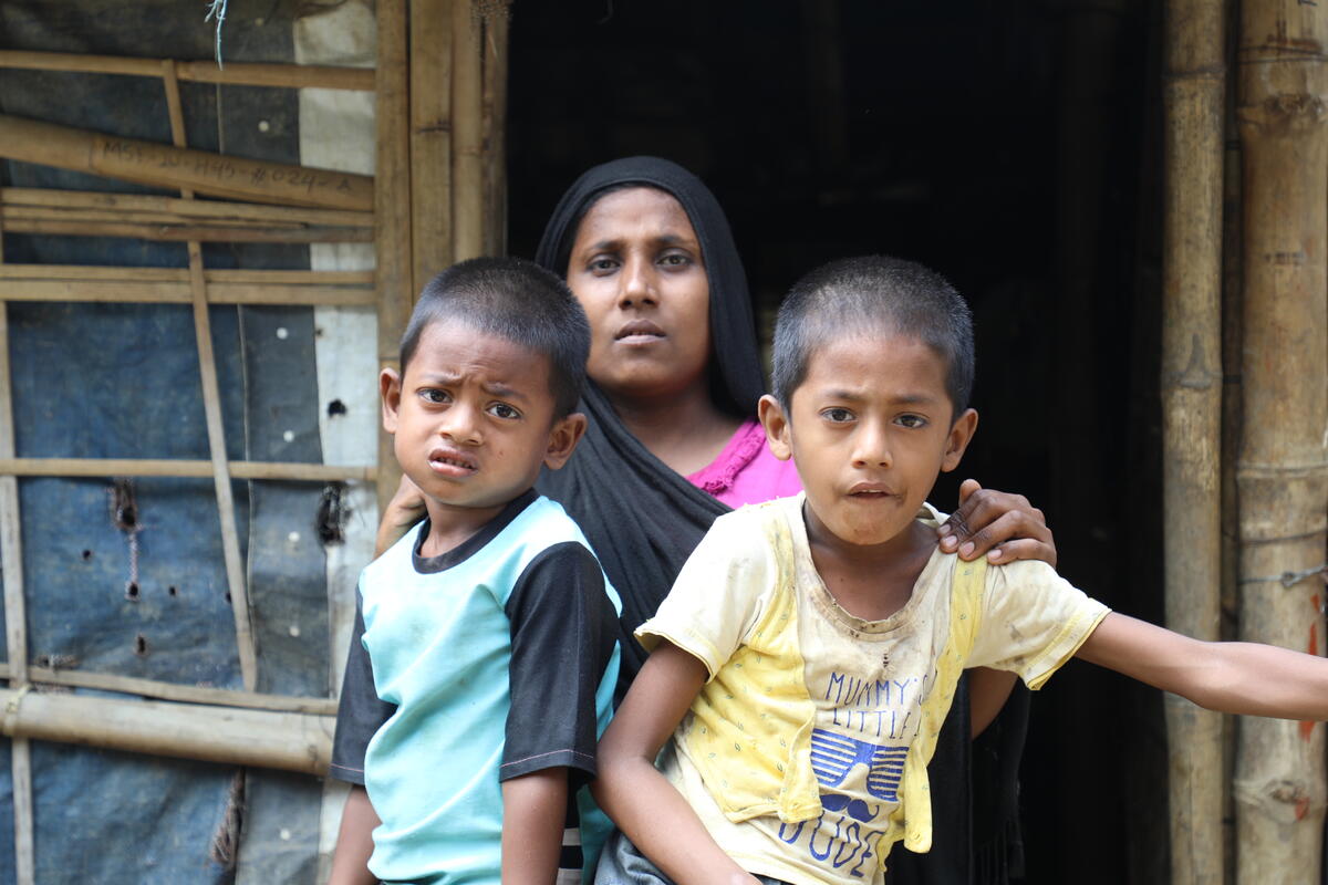 Juhara sits with both her children 