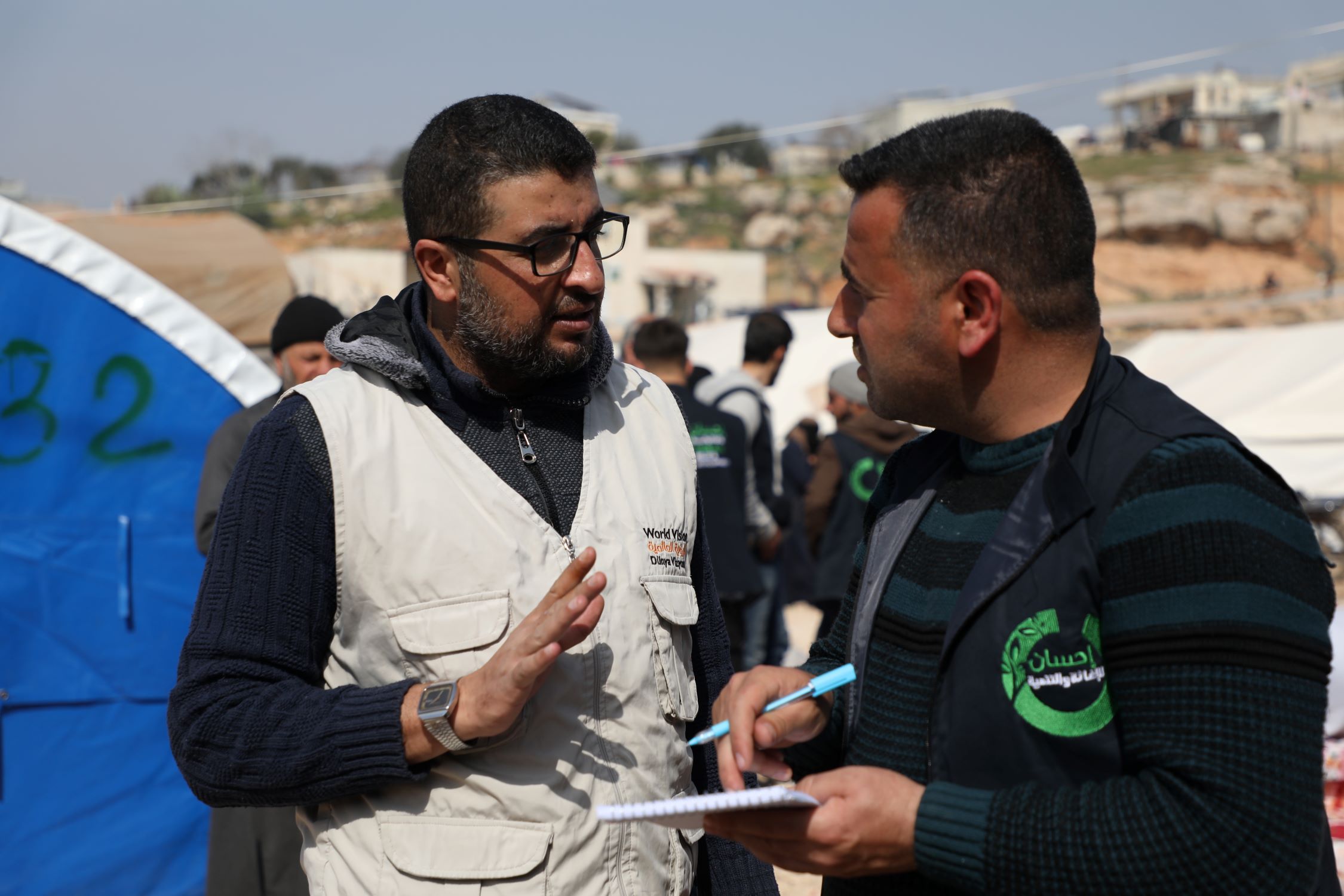 After Syria earthquake 2023, two men discussing action - World Vision and its implementing partner Ihsan Relief and Development.
