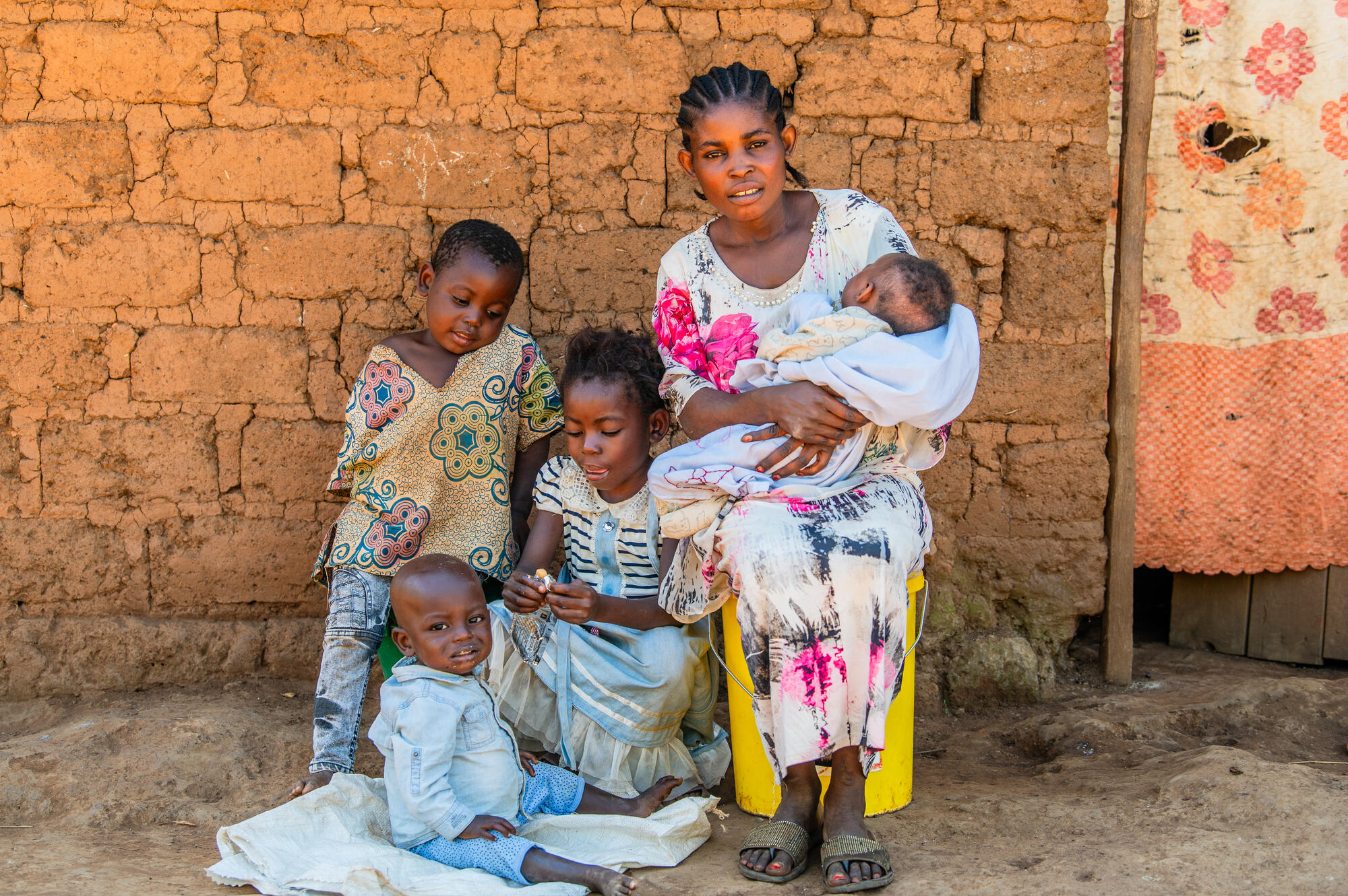 Little Geordy sits with his mother and siblings.