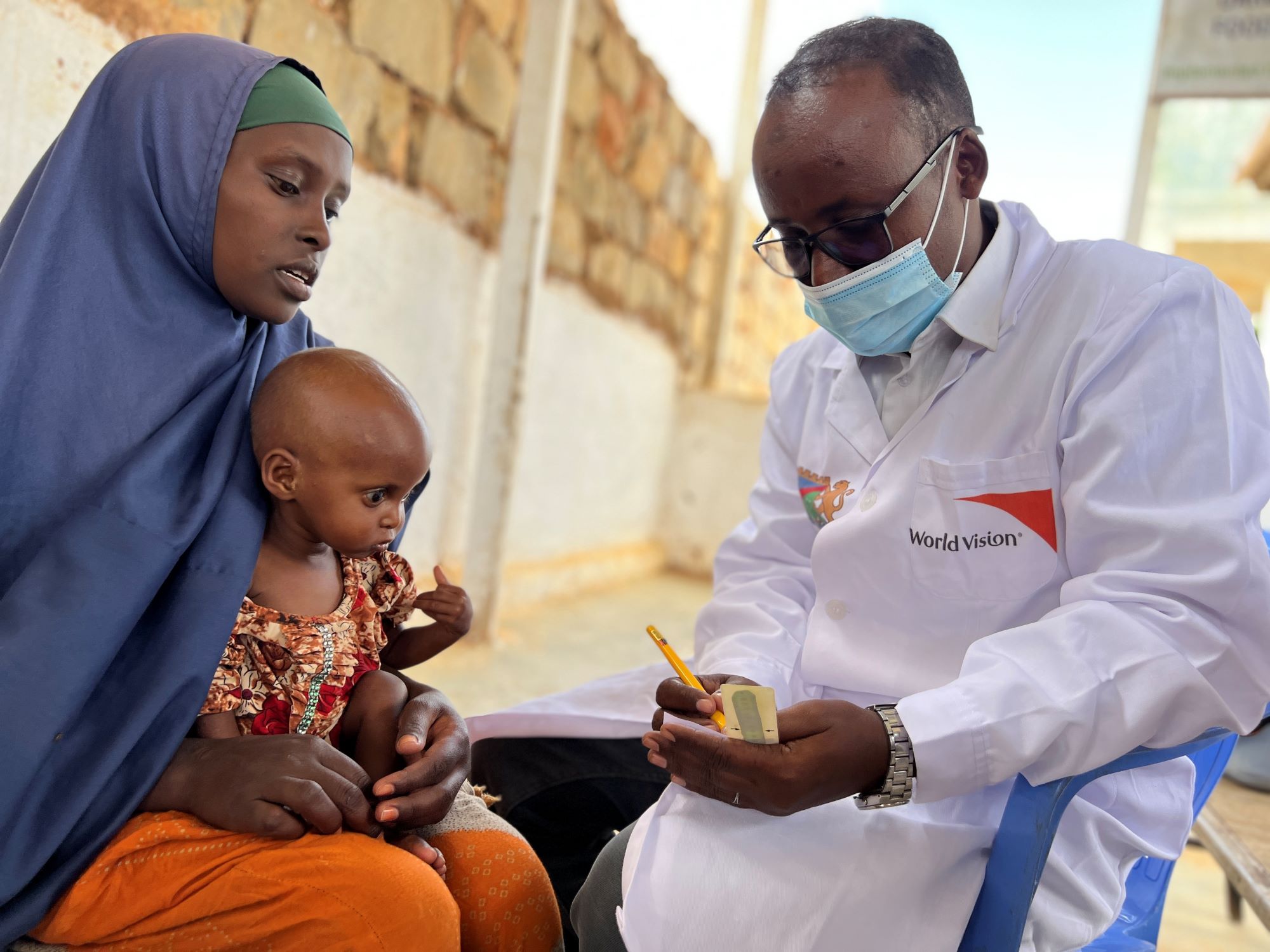 Child from Somalia is treated by World Vision staff during hunger crisis