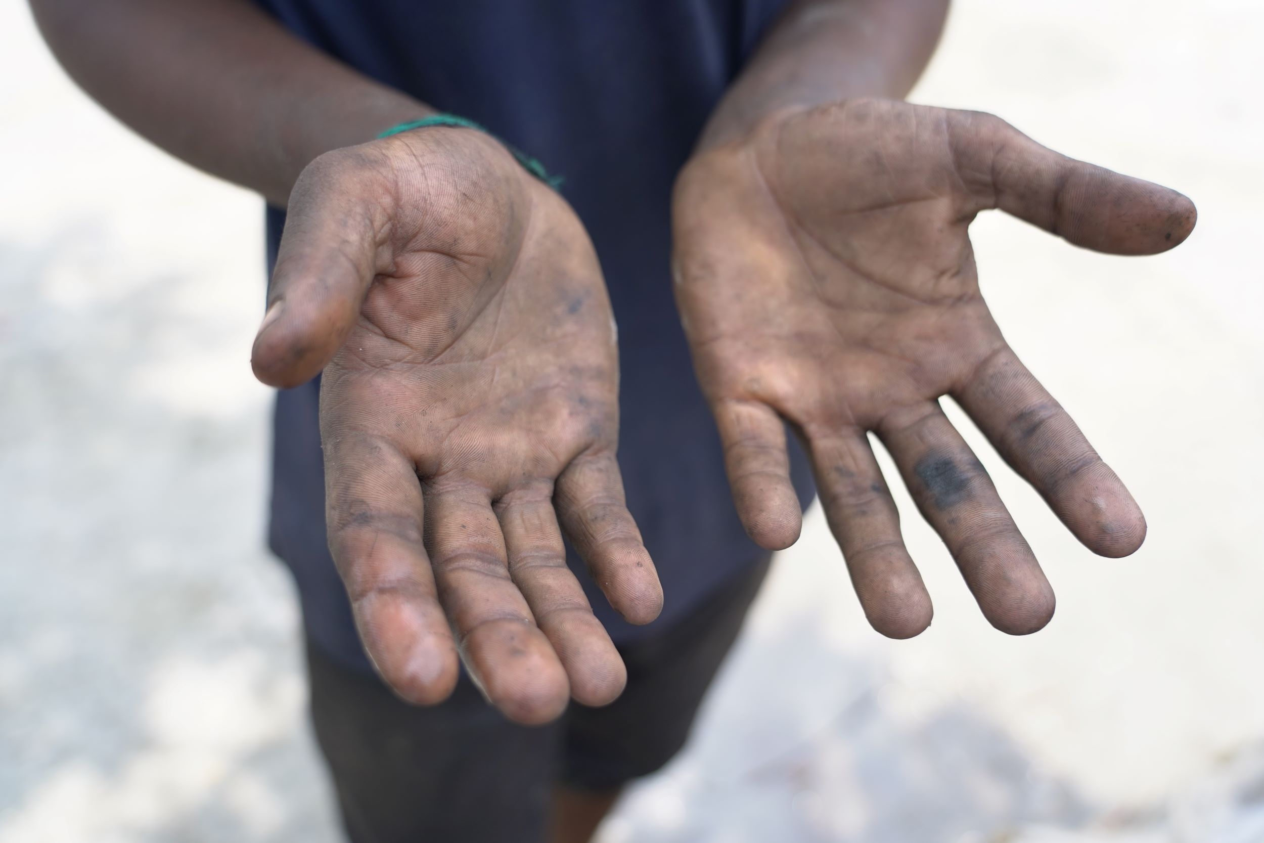 Dirty hands of a young Bangladeshi boy working 12 hours every day