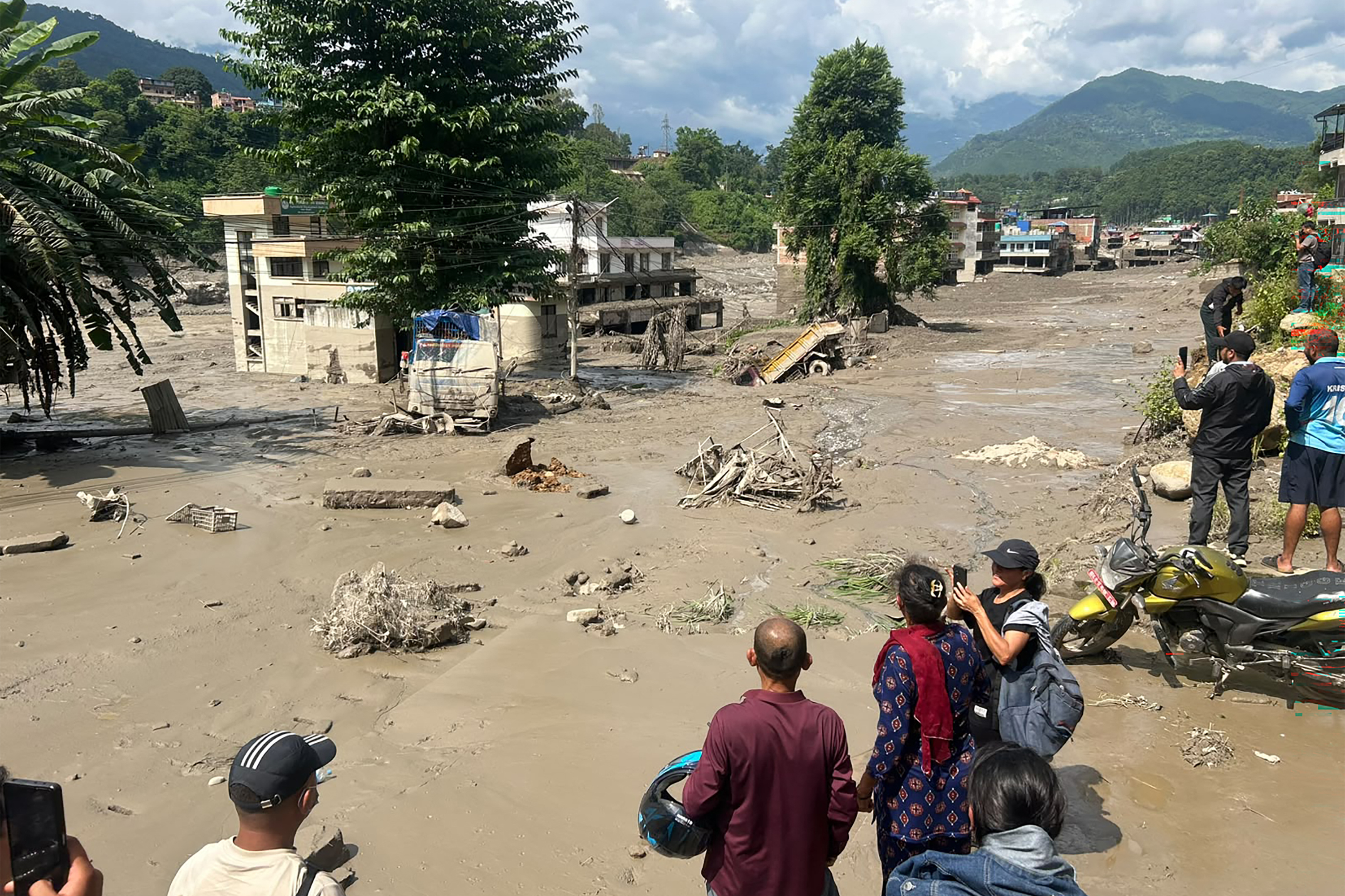 Prakash MATHEMA / AFP via Getty Images. Survivors witnessing the destruction of floods in Nepal as Bhote Koshi River burst its banks in Rasuwa and Nuwakot districts