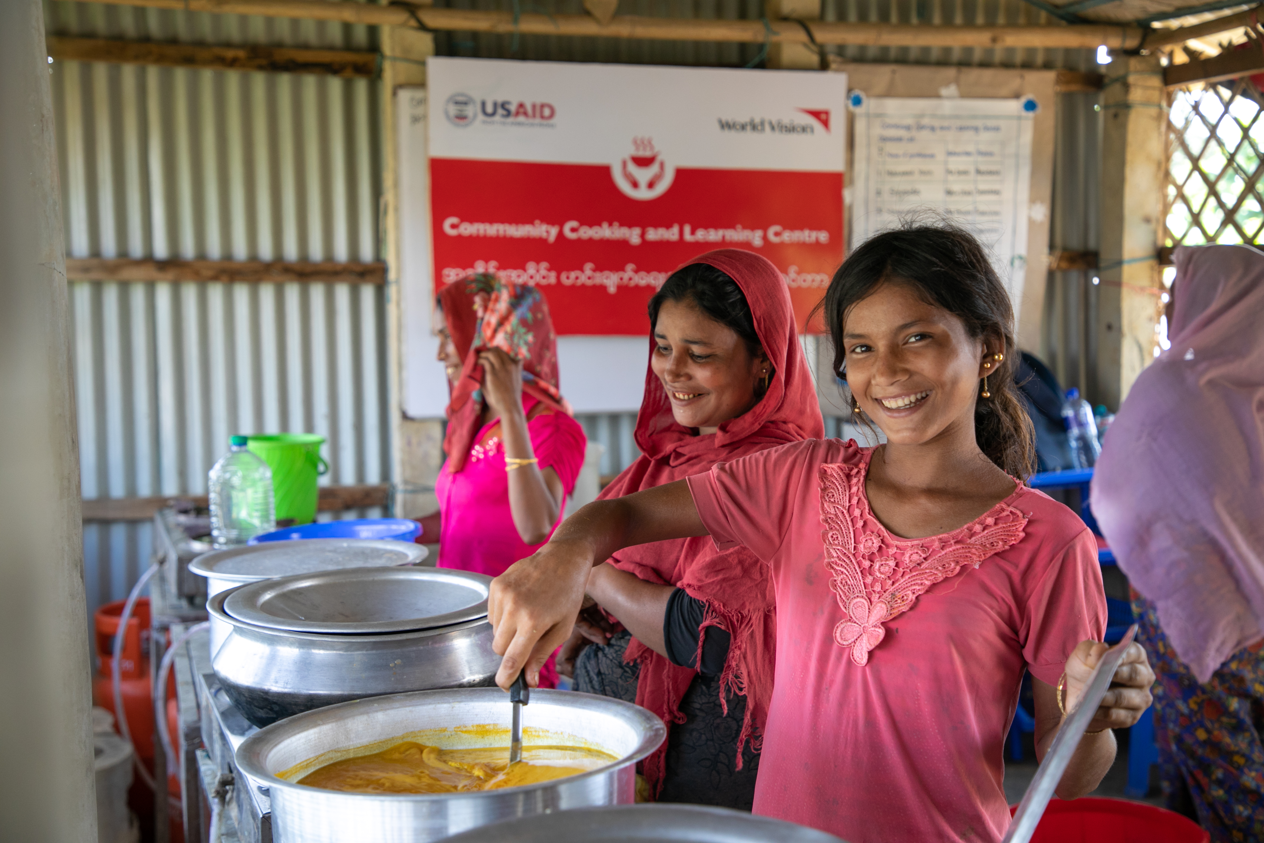 Raju, 12, prepares a meal in this community kitchen in the refugee camp