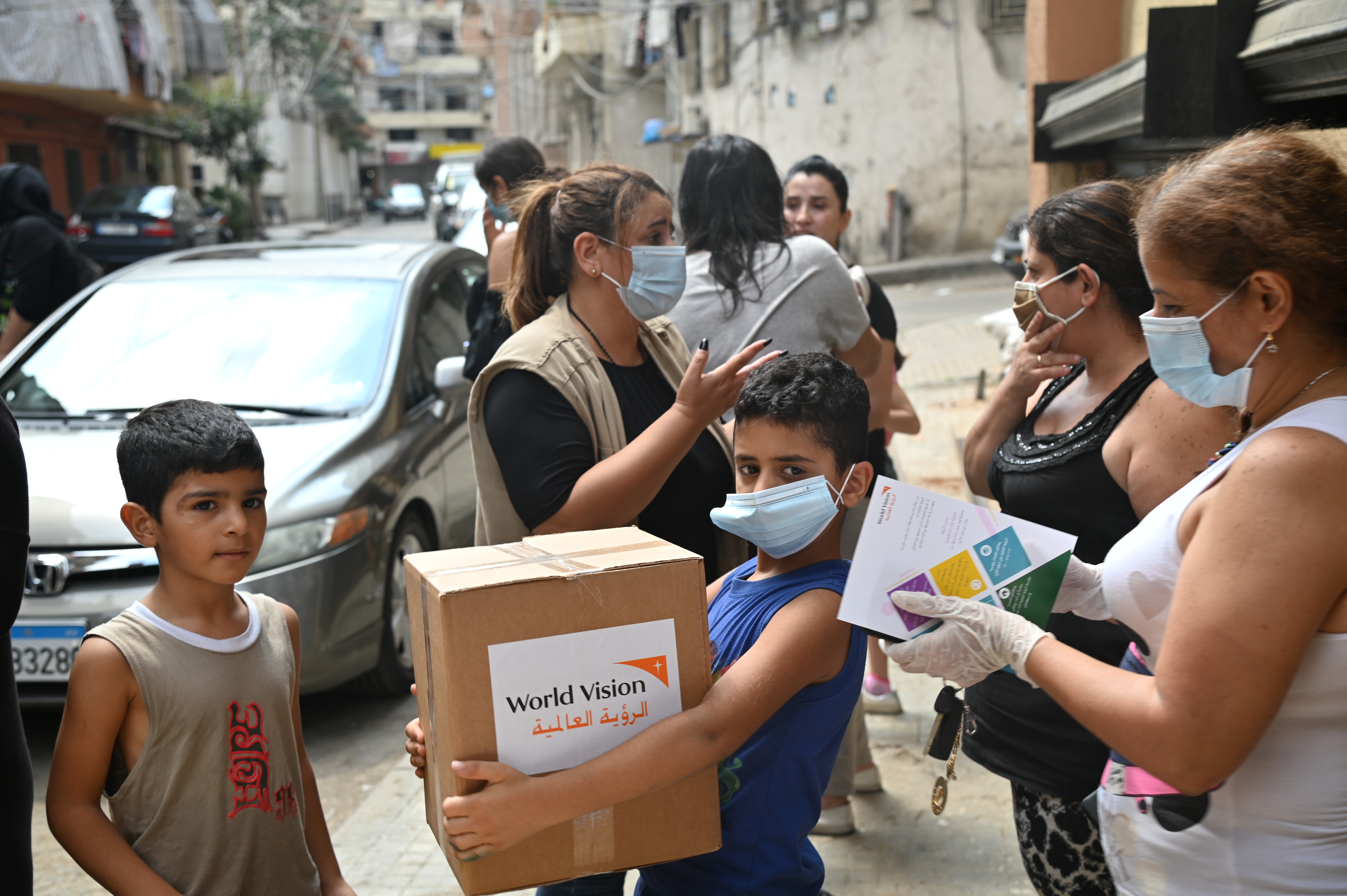 Children in Lebanon hold boxes of aid handed out in the wake of the Beirut explosion