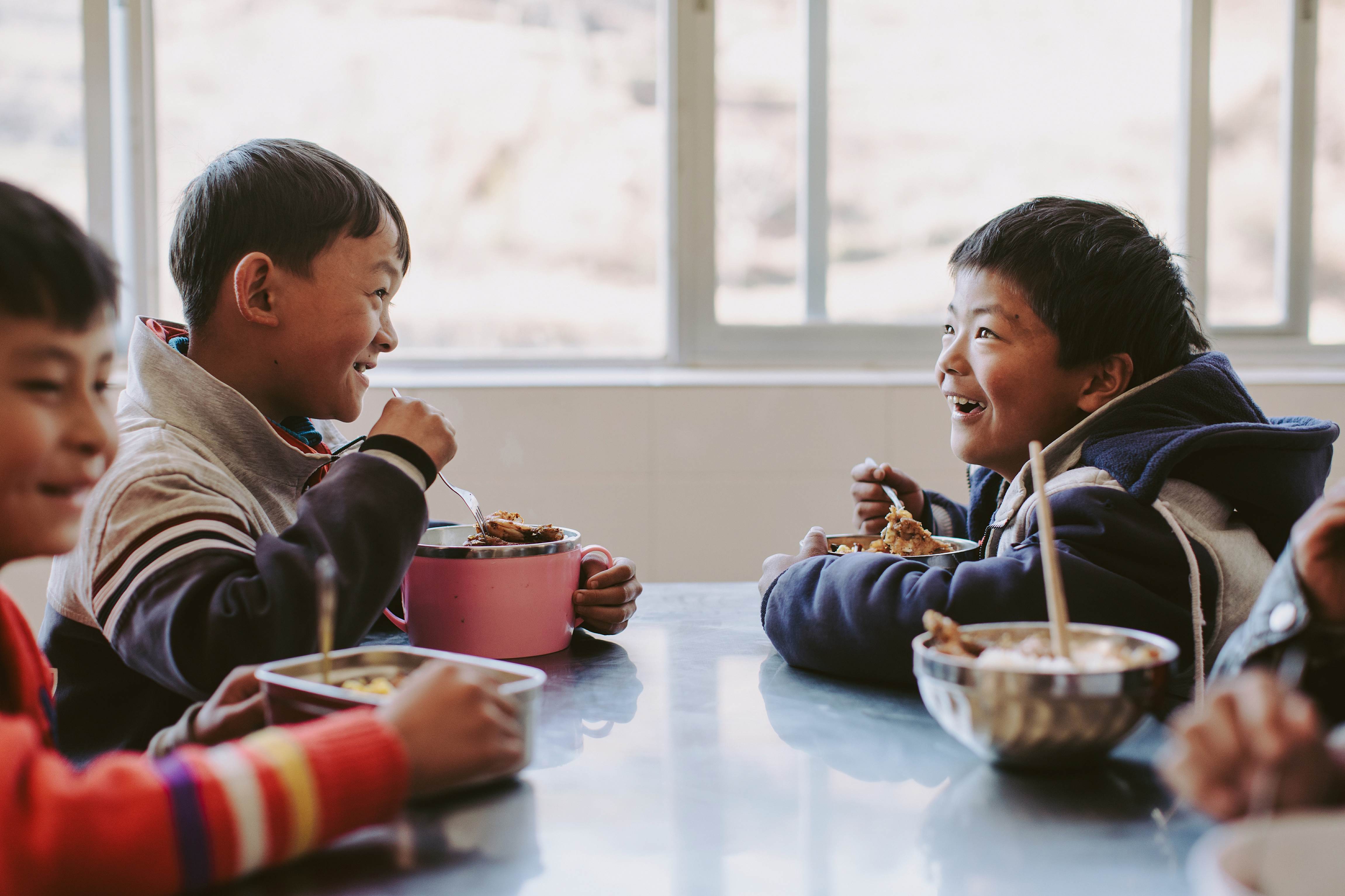 Young Chen eats a school meal with his classmates