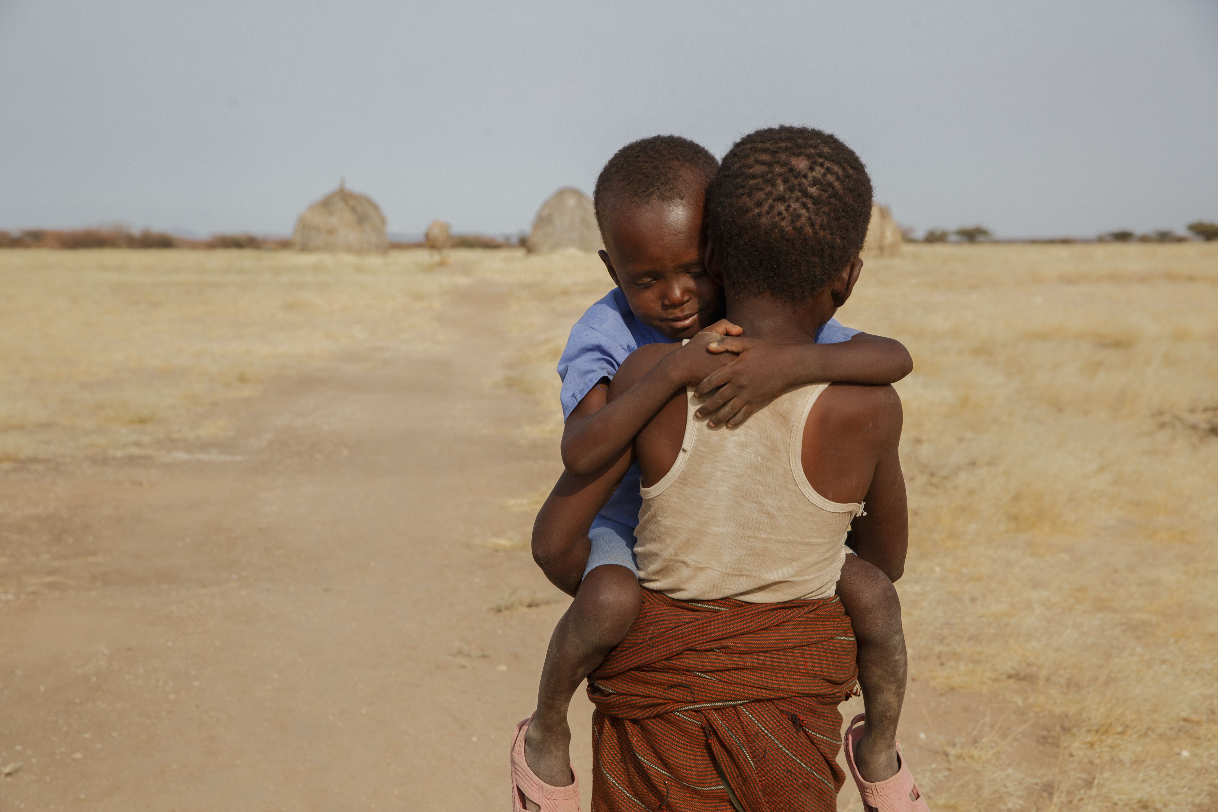 Two young boys walking in drought affected area - global hunger crisis