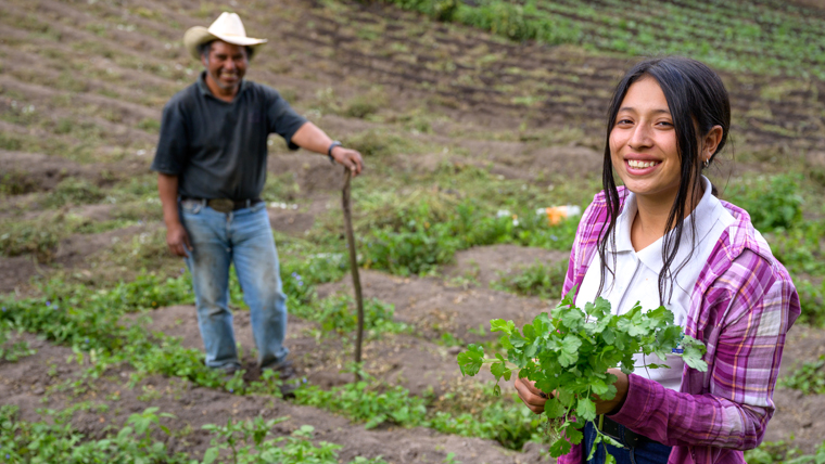 Nahomy, 13, helps her dad in the fields after school