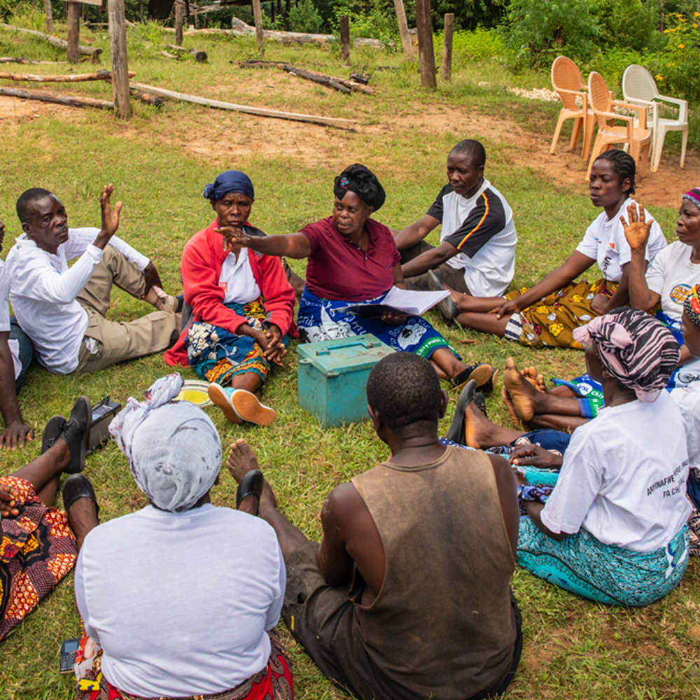 World Vision staff with community sat in a circle